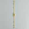 6001_s Vertical gold metal strip mounted on a gray wall with multiple bracket-like blocks and a central rotary switch/joint in the middle
