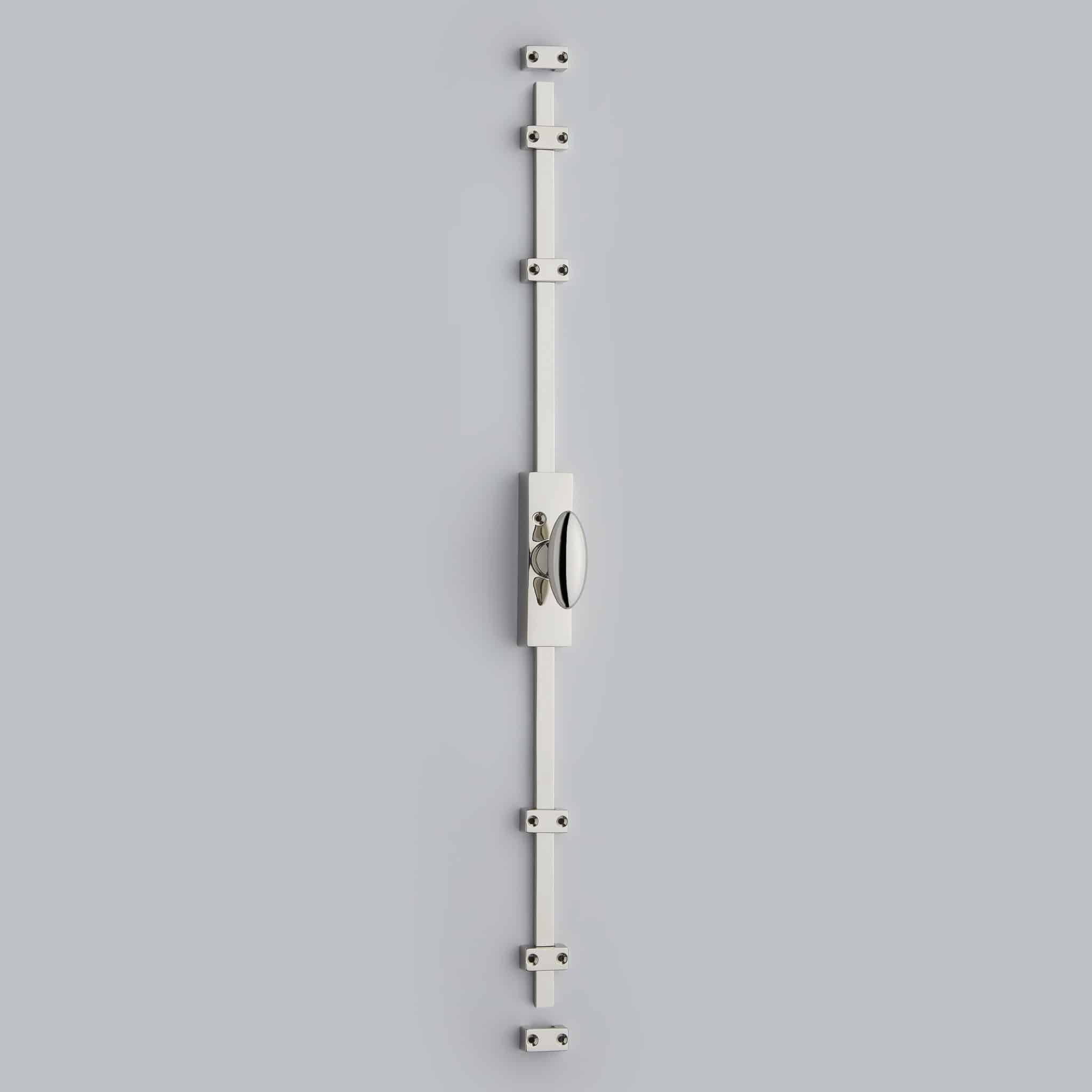 Polished Nickel_01 Vertical aluminum mounting rail with multiple clamp blocks and screws against a gray background, photographed from the front.