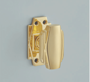 Gold door knob with latch mounted on a light blue door close up