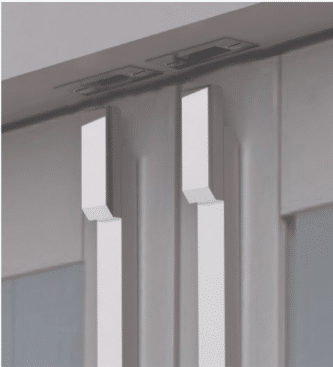 Close up of two vertical metal door handles on a glass door framed by a gray structure