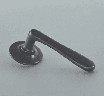 Black metal door lever with round mounting plate on a gray surface