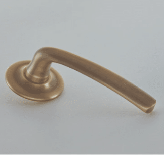 Bronze door lever handle on a circular rose against a light background angled to the right