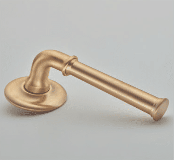 Golden door lever handle with a round escutcheon on a pale gray background