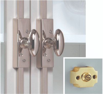 Double door with chrome round doorknobs and latch plates inset shows a yellow plastic door lock cylinder