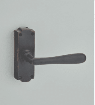 Black lever door handle on a rectangular backplate mounted to a light gray door