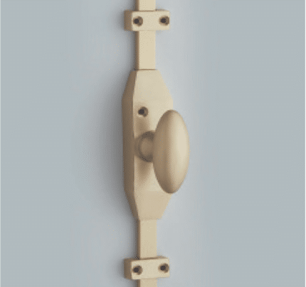 Vertical view of a beige wooden door handle and latch mounted on a light blue wall