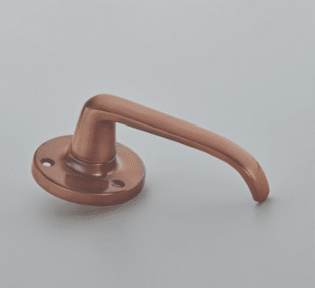 Copper door lever handle with a circular rose plate on a light surface
