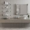 Modern bathroom with a floating vanity, metal open shelving holding towels and toiletries, a round vessel sink, and a potted plant by the window.