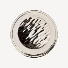 Top down view of a polished stainless steel circular lid with a ridged wavy center