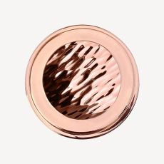 Rose gold round compact containing a marbled pressed powder with a wavy pattern