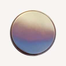 Circular gradient disk with peach purple and blue tones on a white background