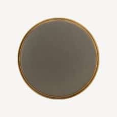 Round dark gray coaster with a light brown rim on a pale background