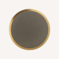 Round plate with a dark gray center and a gold rim on a light background viewed from above