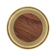 Top down view of a round brass ring surrounding a wooden center seen from above