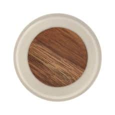 Top down view of a round makeup compact containing brown powder eyeshadow