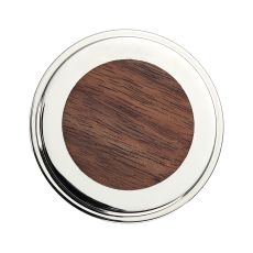 Round metal frame with a dark wood center resembles a coaster or decorative inlay object